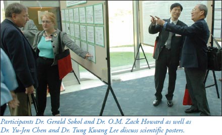 Participants Dr. Gerald Sokol and Dr. O.M. Zack Howard as well as Dr. Yu-Jen Chen and Dr. Tung Kwang Lee discuss scientific posters.